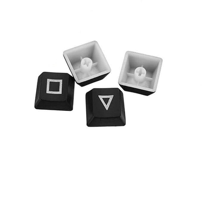 Négy fekete ABS keycap háromszög, kör, X és négyzet szimbólummal, alulról is