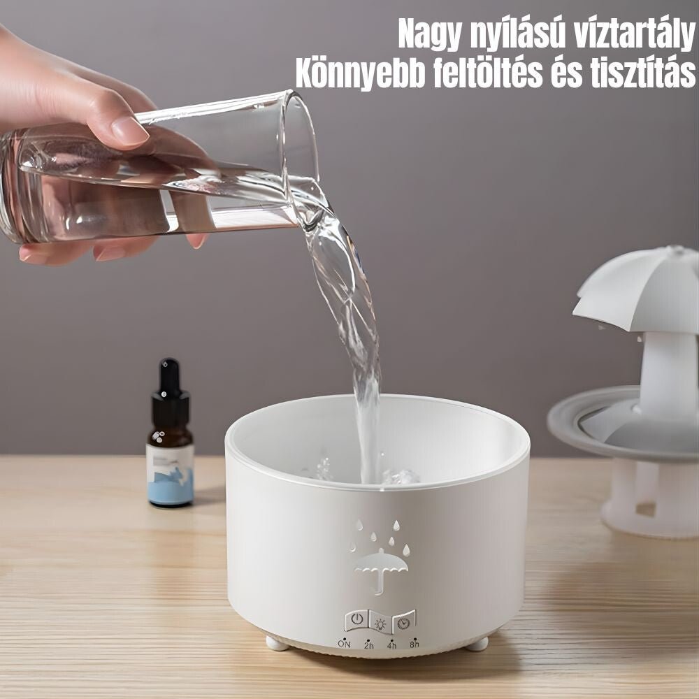 Víz betöltése a diffúzór nagy nyitású tartályába, mellette illóolaj és levett esernyő