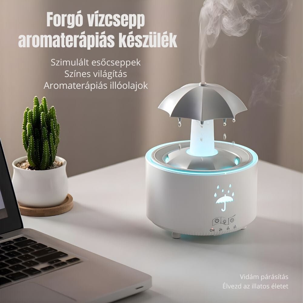 Esőcseppes aromaterapiás készülék laptop és kaktusz mellett, esernyőről csepegő vízzel